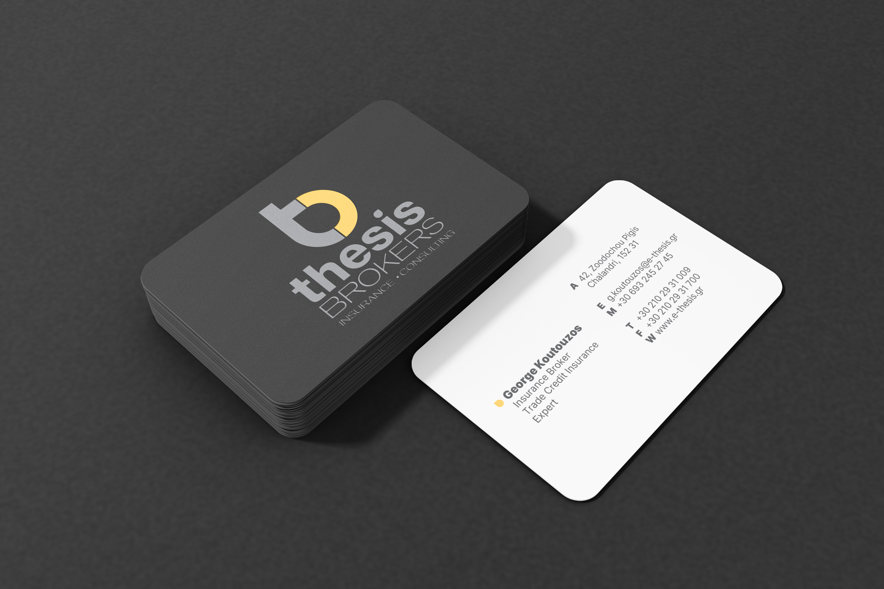 A stack of Thesis Brokers business cards, printed in sunken polar paper and round cutting edges.